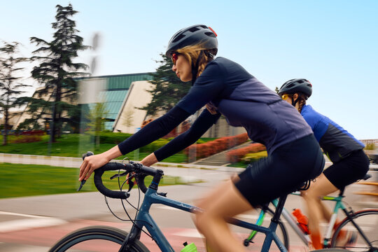 Active women ride their bicycles together