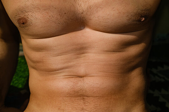 Male Physique Body Skin Tanning Close-up
