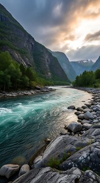 Majestic river flowing through rugged mountain landscape at sunrise.