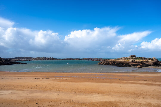 Rocky tidal island under bright skies in Tregastel, Brittany, France