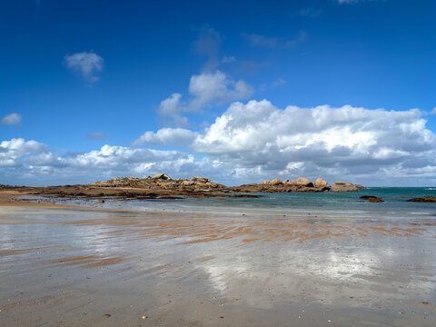 Granite reefs and shallow water along Tregastel Brittany France beach