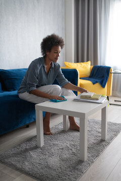 Black female washing table near planners