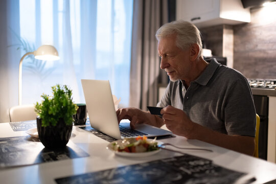 Senior man using laptop for online shopping
