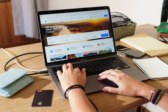 Person Searching Flights on Laptop with Credit Card, travel planning