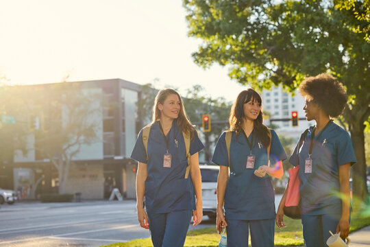 Three Healthcare Workers Walk Down the Street