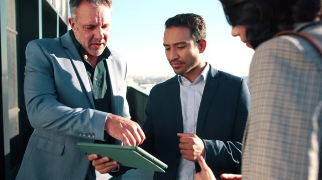 City, meeting and coworkers on balcony with tablet, real estate agent and urban development idea. Realtor, people and discussion outdoor with tech for planning, collaboration and property investment.