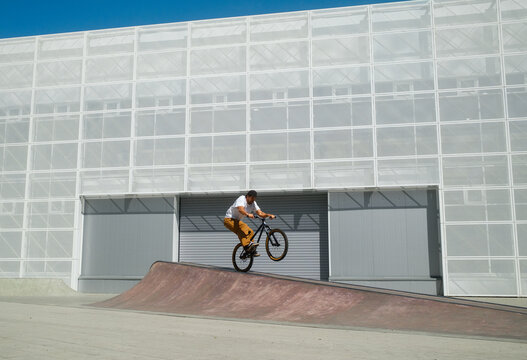 Extreme Rider Performs Balance Trick at Minimalistic Skatepark 
