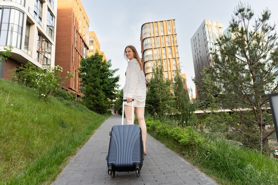 Traveler walking through a landscaped residential courtyard