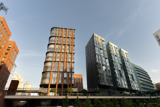Contemporary apartment towers along a quiet urban waterfront