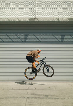 Extreme Bicycle Rider Doing Barspin In Urban Minimalistic Area