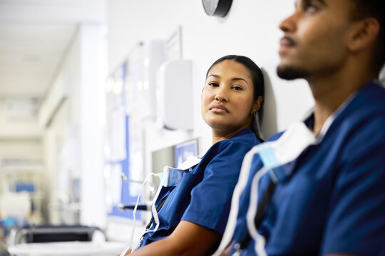 Healthcare Workers Rest in Hospital Hallway
