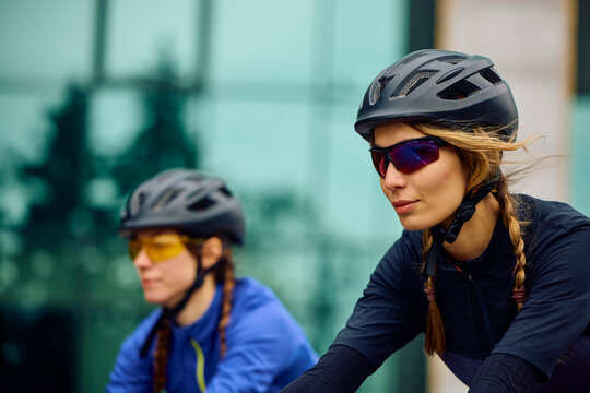 Smiling women ride bicycles