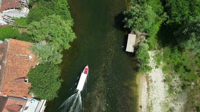 Aerial top-down view of a boat on Rijeka Crnojevica, Montenegro