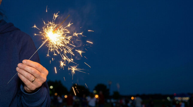 Close up of sparkler burning, joyful celebration, night background, with copy space