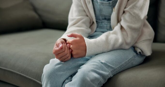 Anxiety, hands and nervous with child on sofa in home living room for concern or worry. Ptsd, stress and trauma with guilty girl thinking in apartment for confession of failure, mistake or regret