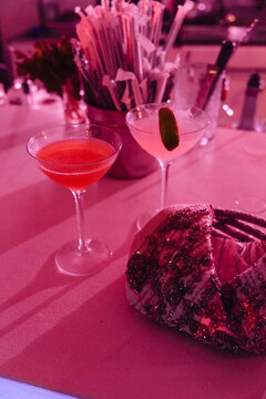 Two Cocktails Sit on a Bar With a Purse in Soft Light