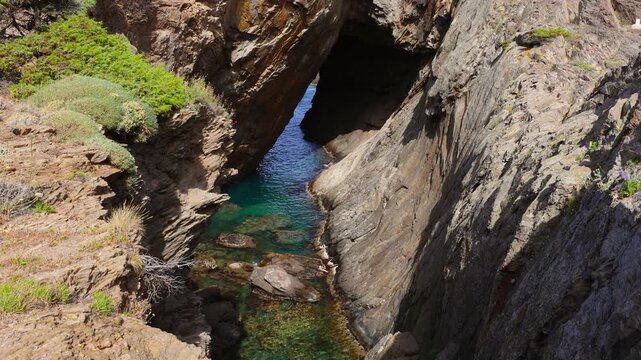 Peaceful turquoise sea waves at Cova de s'Infern sea cave in Cap de Creus Natural Park, Costa Brava, Catalonia, Spain