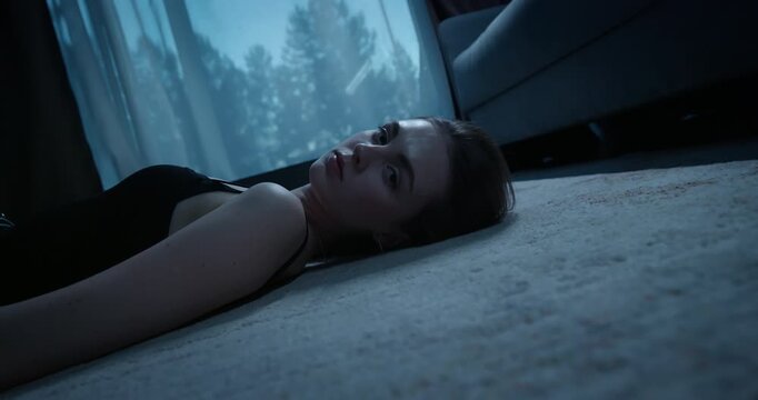 Woman silhouette in dark room. Sad girl lying on floor feel sorrow, loneliness. Melancholy mood, depression concept. Person in deep thought at night. Lonely reflecting thinking on life, solitude.