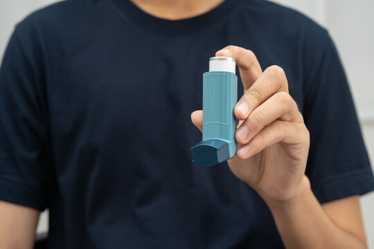Asthma and chronic obstructive pulmonary disease COPD, Asian teenage using metered dose inhaler MDI.