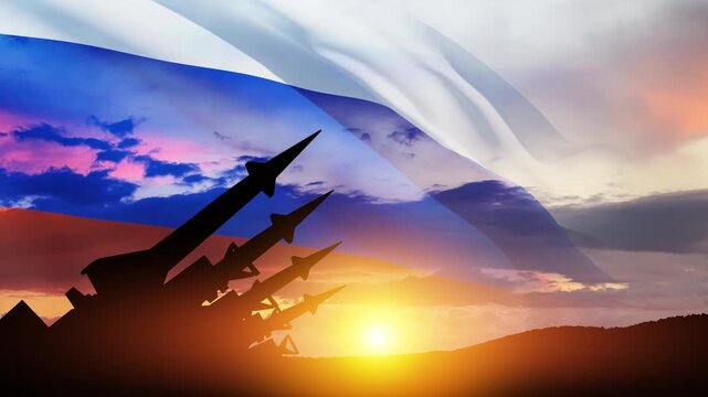 The missiles are aimed at the sky at sunset with Russian flag. Nuclear bomb, chemical weapons, missile defense, a system of salvo fire.