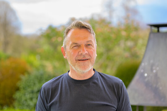 Smiling Mature Man Winking Outdoors