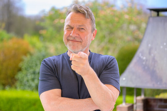 Confident Man Pointing With Wink