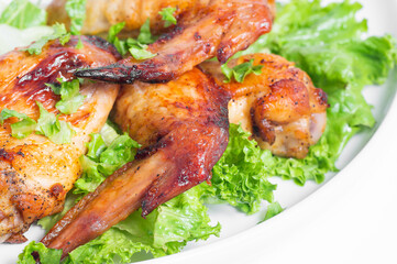 Fototapeta premium Fried chicken wings with herbs. Close-up.