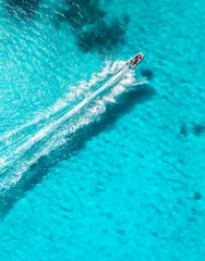 Aerial drone view of floating speed boat in blue sea on sunny day. Summer vacation. Mallorca island, Spain. Top down view of boat, sea, turquoise water. Travel. Tropical landscape. Yachting. Cruise © den-belitsky