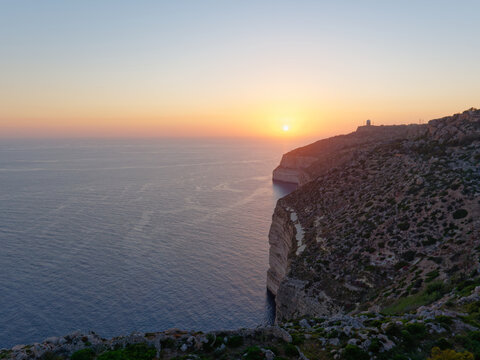 Spectacular golden sunset over the Mediterranean Sea along the high rocky coastline at Dingli Cliffs, Malta