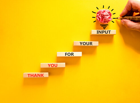 Thank you for your input symbol. Concept words Thank you for your input on beautiful wooden blocks. Beautiful yellow background. Businessman hand. Business thank you for your input concept. Copy space