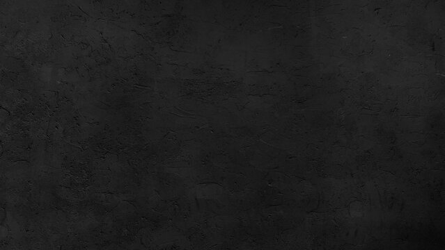 Dark Black Concrete Plaster Wall Texture Background Rough Cement Surface with Grungy Plastering Details and Fine Cracks Empty Noir Vignette Backdrop for Product Photography Copy Space.