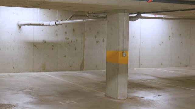 Empty underground concrete parking garage basement, copy space