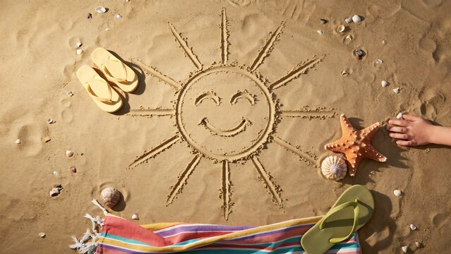Summer beach scene with sand drawing and accessories