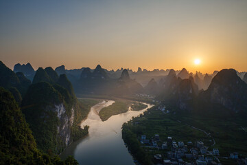 Naklejka premium Sunrise over Li River Karst Mountains near Guilin, China