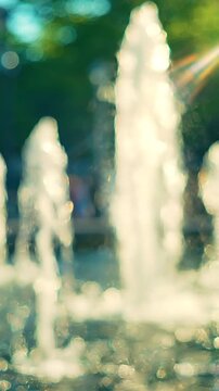 A Captivating Display of Water Fountains in Motion, Showcasing the Beauty and Charm of Water Elements Against a Blurred Natural Background