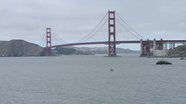Golden Gate Bridge From Rocky Beach On Overcast Day In San Francisco - Cinematic Aerial Shot