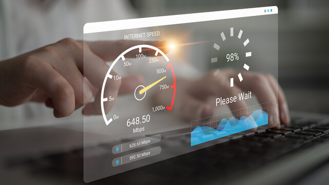 A user interacts with a laptop displaying an internet speed test, showcasing performance metrics and a loading indicator in a contemporary home office environment. Ledger