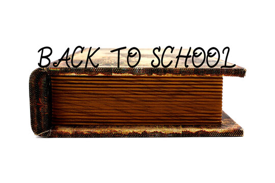 Antique book lying flat with the text "back to school," isolated on a white background. Storage box shaped like a book.
