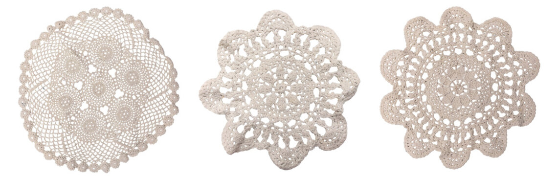 Round white crochet lace doilies with traditional knit patterns on a transparent background