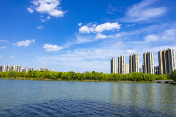 Urban Lakefront Skyline with High-Rise Towers and Blue Sky © LamQuang