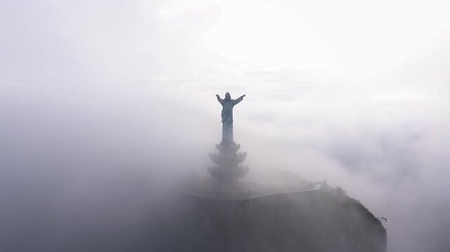 Drone View of Jesus Statue Surrounded by Fog in Tana Toraja