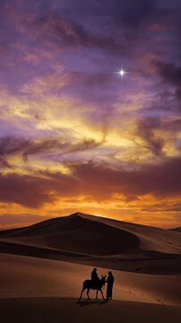 Woman riding a donkey with a man leading through the desert under a bright star. Nativity scene concept at sunset with silhouettes against the sand sky. Vertical video