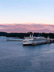 Fototapeta premium Ferry Docked at Swartz Bay With Pink Sunset Clouds Over Vancouver Island, British Columbia, Canada
