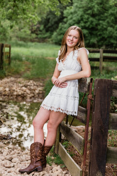 Portrait of teen girl leaning on fence