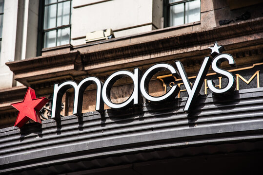 Exterior architectural detail of the Macy's flagship department store entrance and brand sign at Herald Square in New York City.