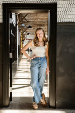 Portrait of a young woman standing in a doorway