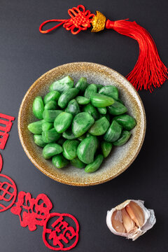 Green Laba Garlic in Bowl with Chinese New Year Decorations