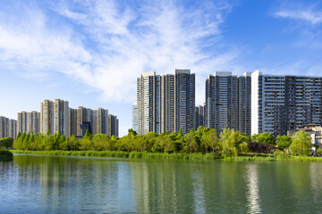 Modern Residential High-Rise Buildings by Lakeside Park Under Blue Sky © PhungBao