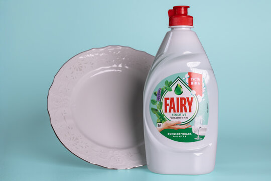 Fairy Sensitive Tea Tree and Mint dishwashing liquid white plastic bottle on turquoise background