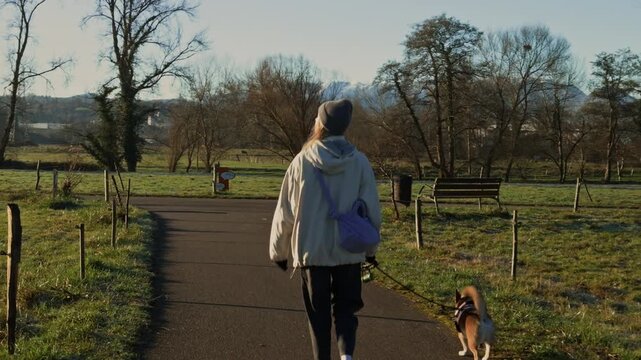 Walking behind woman with dog in beautiful Asturias park.

Relaxing outdoor lifestyle video featuring nature, autumn colors and panoramic snowy peaks surrounding Oviedo.